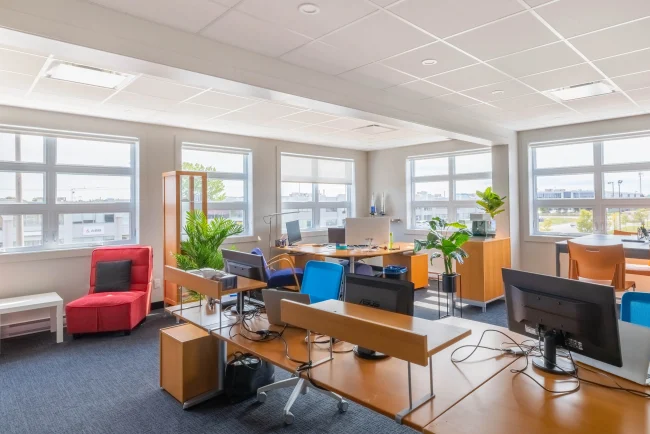 Loft office with workstations and a beautiful light.